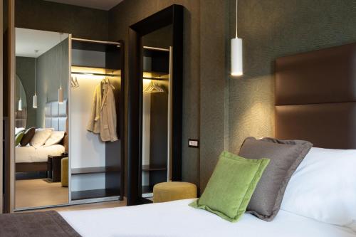 a bedroom with a bed and a large mirror at San Severino Park Hotel & SPA, BW Signature Collection in Mercato San Severino