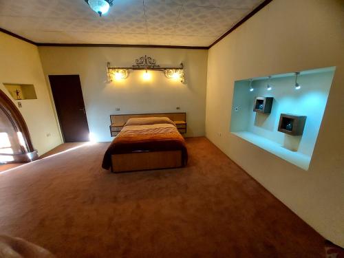 a bedroom with a bed and lights on the wall at Ñaupa House Hostel in Cochabamba