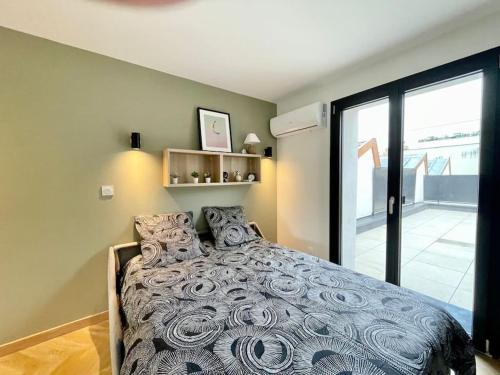 a bedroom with a bed and a large window at Le Flachet - Climatisation - Wifi in Villeurbanne