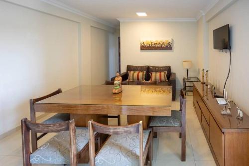 a dining room with a table and chairs and a couch at Best Parque - Pileta y Cochera - Solo autos in San Miguel de Tucumán