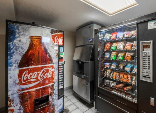a refrigerator with a bottle of coke and other drinks at Red Roof Inn Greensboro Airport in Greensboro