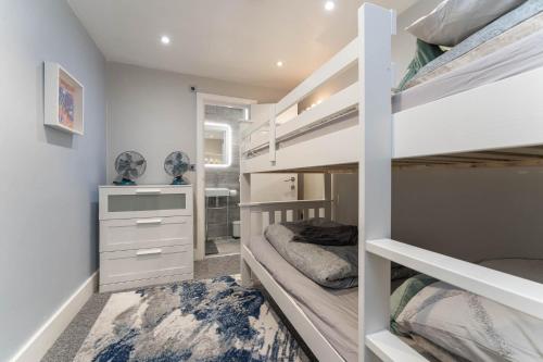 a bedroom with two bunk beds and a desk at Sealanes 2 in Brighton & Hove