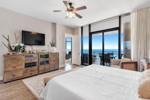 a bedroom with a bed and a flat screen tv at Capri 601 in Perdido Key