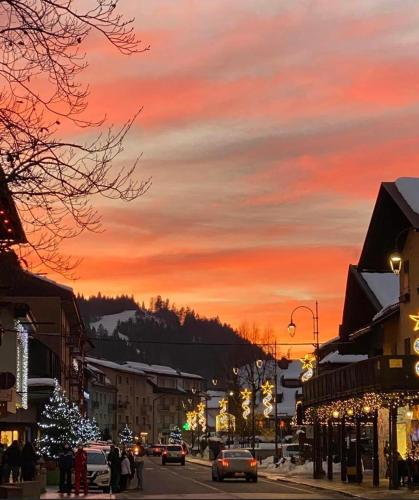 a city street at sunset with cars driving down the street at A CASA DI LETY in Tarvisio