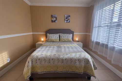 a bedroom with a bed and two candles on two night stands at Cozy Downtown One Bedroom Condo Jacksonville in Jacksonville