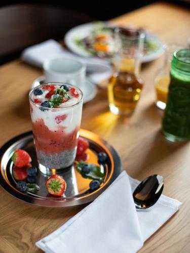 a table with a drink and a plate of food at The Viaduct - Suites & More in Prague