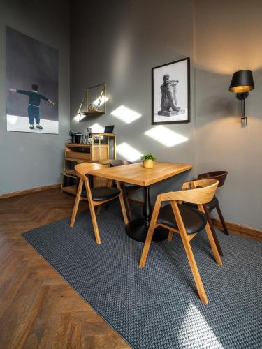 a dining room with a wooden table and chairs at The Viaduct - Suites & More in Prague