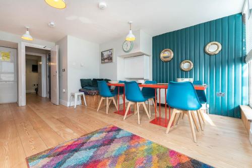 a kitchen and living room with a table and chairs at Sealanes 2 in Brighton & Hove