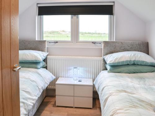 a bedroom with two beds and a window at Appaloosa Suite - Uk41831 in Tickton