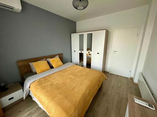 a bedroom with a large bed with yellow pillows at Yellow Apart @ Vitosha, Sofia in Sofia