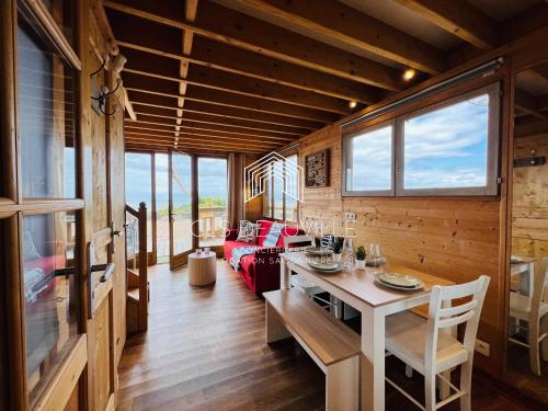 a living room with a table and a couch at Chalet Bord de Mer CLS Deauville in Cricquebœuf