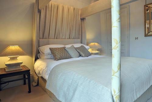 a bedroom with a bed and two tables with lamps at Royal Parade Apartments in Harrogate