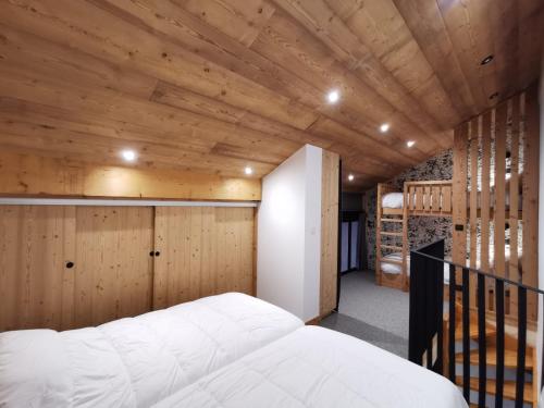 a bedroom with wooden walls and a bed in a room at Arcs 1950 , CALM Comme A La Montagne in Arc 1950