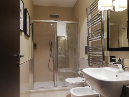 a bathroom with a shower and a sink and a toilet at Napoli Mariana Luxury in Naples