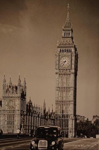 a car parked in front of big ben and big clock tower at Bright, Nice Interior, Close to the City, 2 Bedroom Apartment in London