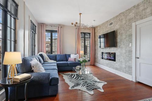 a living room with a blue couch and a zebra rug at St Charles-Mardi Gras 6BD Home in New Orleans