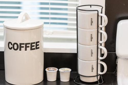 a coffee maker and two cups on a counter at Skyrise Two Stories - Centrally Located in Brookline