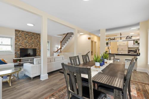 a dining room and living room with a table and chairs at Skyrise Two Stories - Centrally Located in Brookline