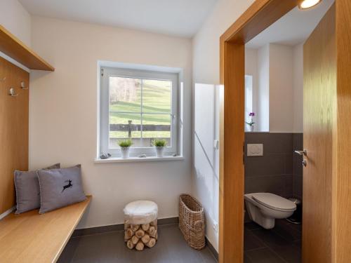 a bathroom with a toilet and a window at Ferienhaus Wirtheim in Brixen im Thale