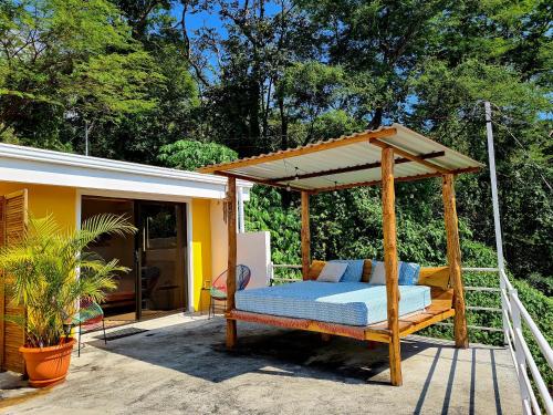 a bed with a canopy on a patio at La Casa del Conde in Naranjo