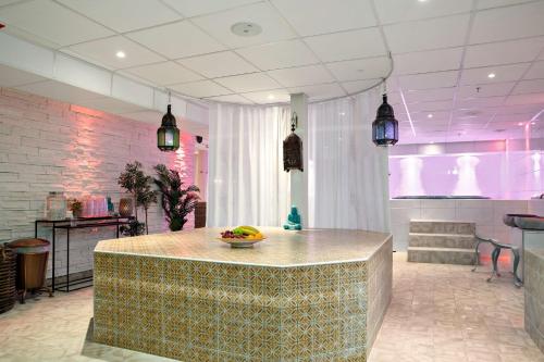 a kitchen with a counter with a bowl of fruit on it at Best Western Hotel Gamla Teatern in Östersund
