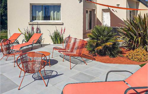 a group of chairs and tables on a patio at Lovely Home In Pordic in Pordic