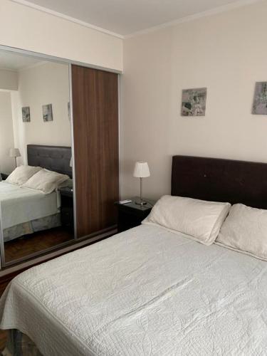 a bedroom with two beds and a large mirror at Barrancas de Belgrano in Buenos Aires
