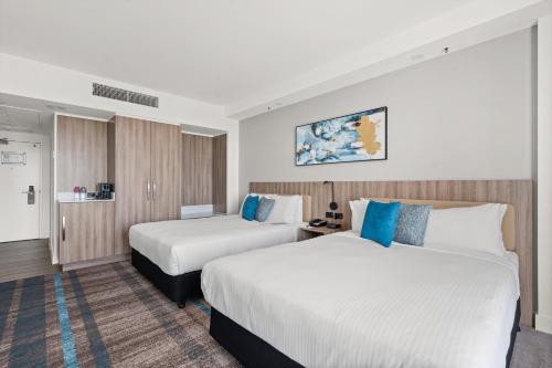 a hotel room with two beds in a room at Crowne Plaza Surfers Paradise by IHG in Gold Coast