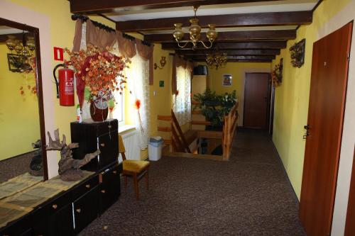 a hallway with a table and a chair in a room at Agropensjonat Stręgielek in Stręgielek