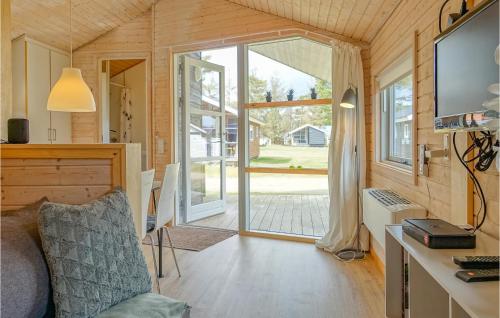 a living room with a large sliding glass door at Gorgeous Home In Nexø With Kitchen in Neksø