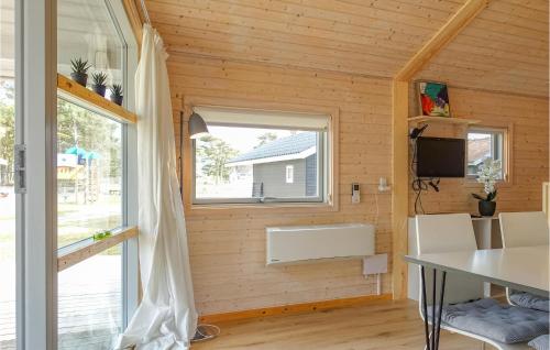 a room with a window and a table and a tv at Gorgeous Home In Nexø With Kitchen in Neksø
