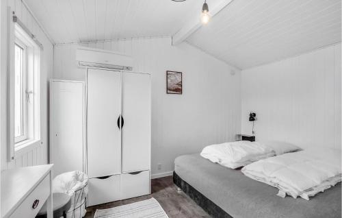 a white bedroom with a bed and a cabinet at Cozy Home In Roslev With Wifi in Roslev