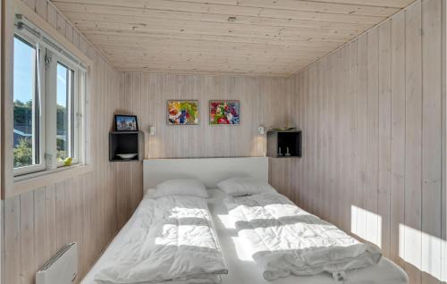 a bedroom with a large bed in the corner at Lovely Home In Lgstr With Kitchen in Løgstør