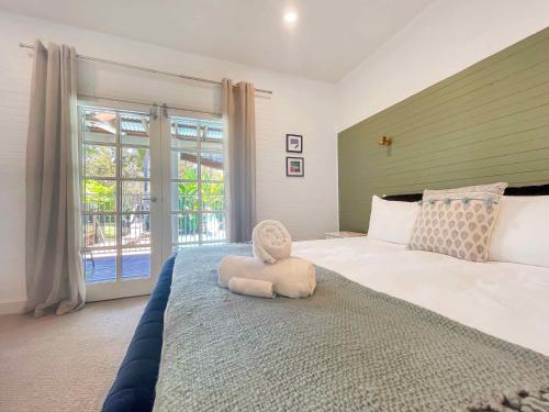 a bedroom with a bed with a stuffed animal on it at Alfie's Place in Nulkaba