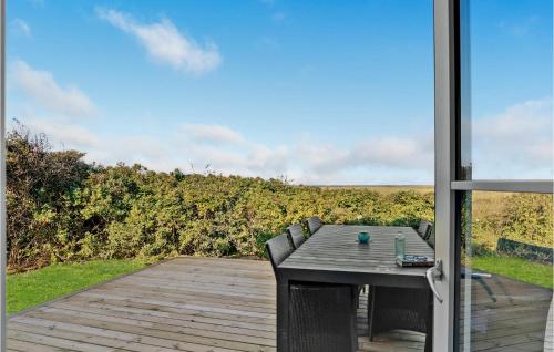 a patio with a table and chairs on a deck at Lovely Home In Løgstør With Kitchen in Løgstør