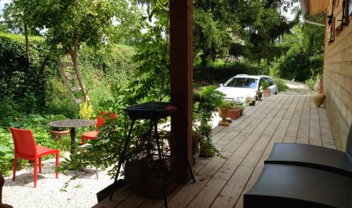 a patio with a table and chairs and a car at 116 Espigarie in Le Vigan