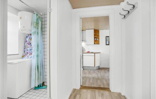 a white hallway with a door leading to a kitchen at Awesome Apartment In Bandholm With Kitchen in Bandholm