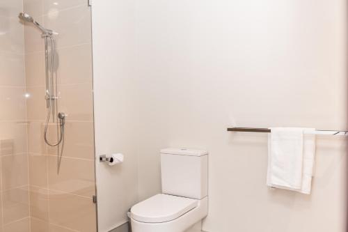 a bathroom with a toilet and a shower at Alexandra Hills Hotel in Cleveland