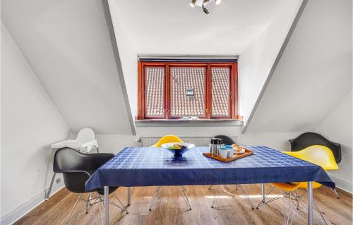 a dining room with a blue table and yellow chairs at Awesome Apartment In Otterup With Wifi in Otterup