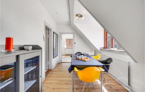 a dining room with a table and yellow chairs at Awesome Apartment In Otterup With Wifi in Otterup