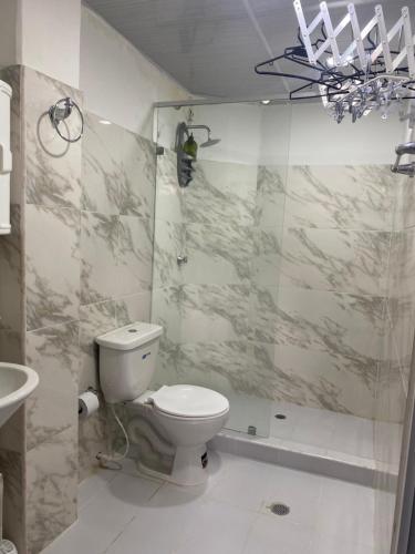 a bathroom with a toilet and a shower at Hostal La Princesa in Cartagena de Indias