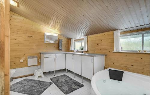a bathroom with a toilet and a sink and a tub at Amazing Home In Farsø With Wifi in Farsø