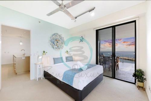 a bedroom with a large bed and a balcony at ZEN POINT PENTHOUSE 3-BR Executive W/front Retreat in Darwin