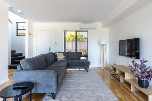 a living room with a couch and a tv at Town Haus in Margaret River Town