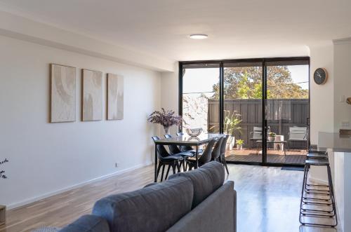 a living room with a couch and a table at Town Haus in Margaret River Town