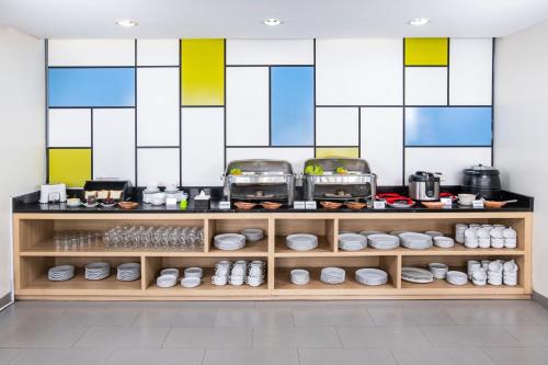 a kitchen with a counter with two toaster at Hotel Citradream Bandung in Bandung