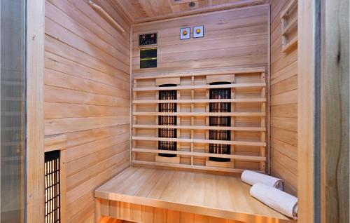 a sauna with a bench in a wooden wall at Beautiful Home In Klenovnik With Sauna in Klenovnik