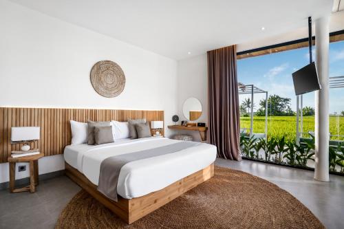 a bedroom with a large bed and a large window at Villa Nature View by BaliSuperHost in Ubud