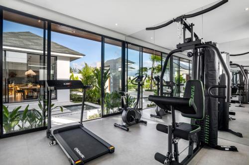 an indoor gym with treadmills and a treadmill at Villa Nature View by BaliSuperHost in Ubud