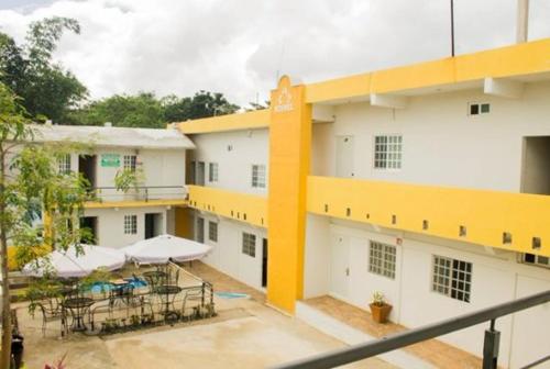 a balcony of a building with tables and umbrellas at Rosvel in Palenque